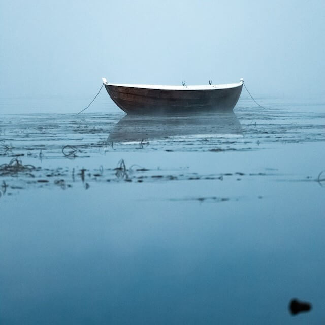 Blue boat on still water