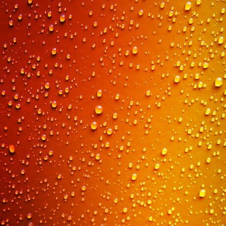 An image of water droplets on an orange background